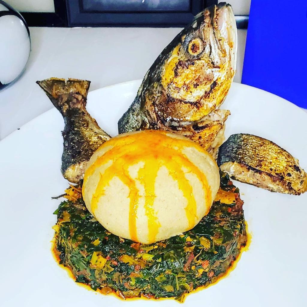 Whole grilled fish with pounded yam and efo riro