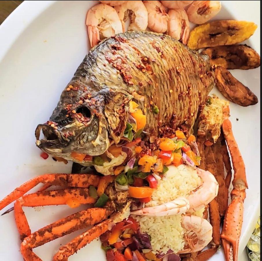 Grilled tilapia with shrimp, plantain and rice