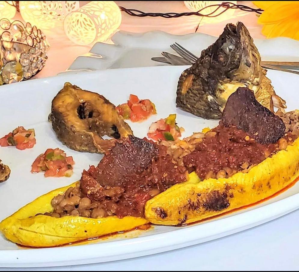 Whole fried fish with plantain, beans and stew